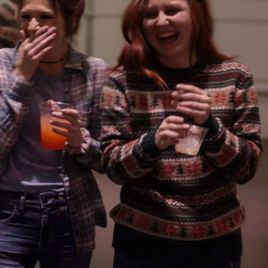 Girls with drinks in their hands, smiling and laughing.