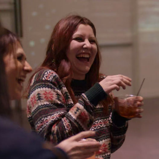 Girls with drinks laughing.