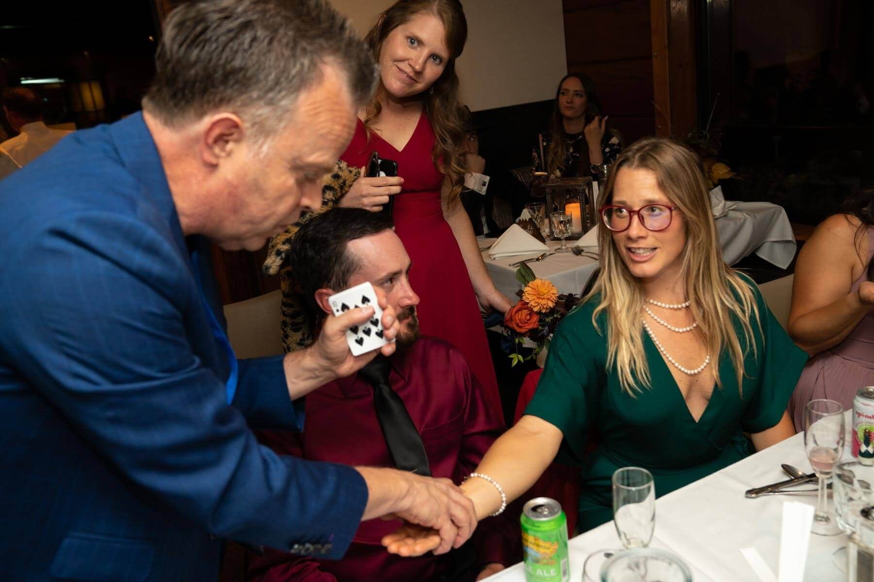 Woman at Wedding being Amazed by Magic Trick.