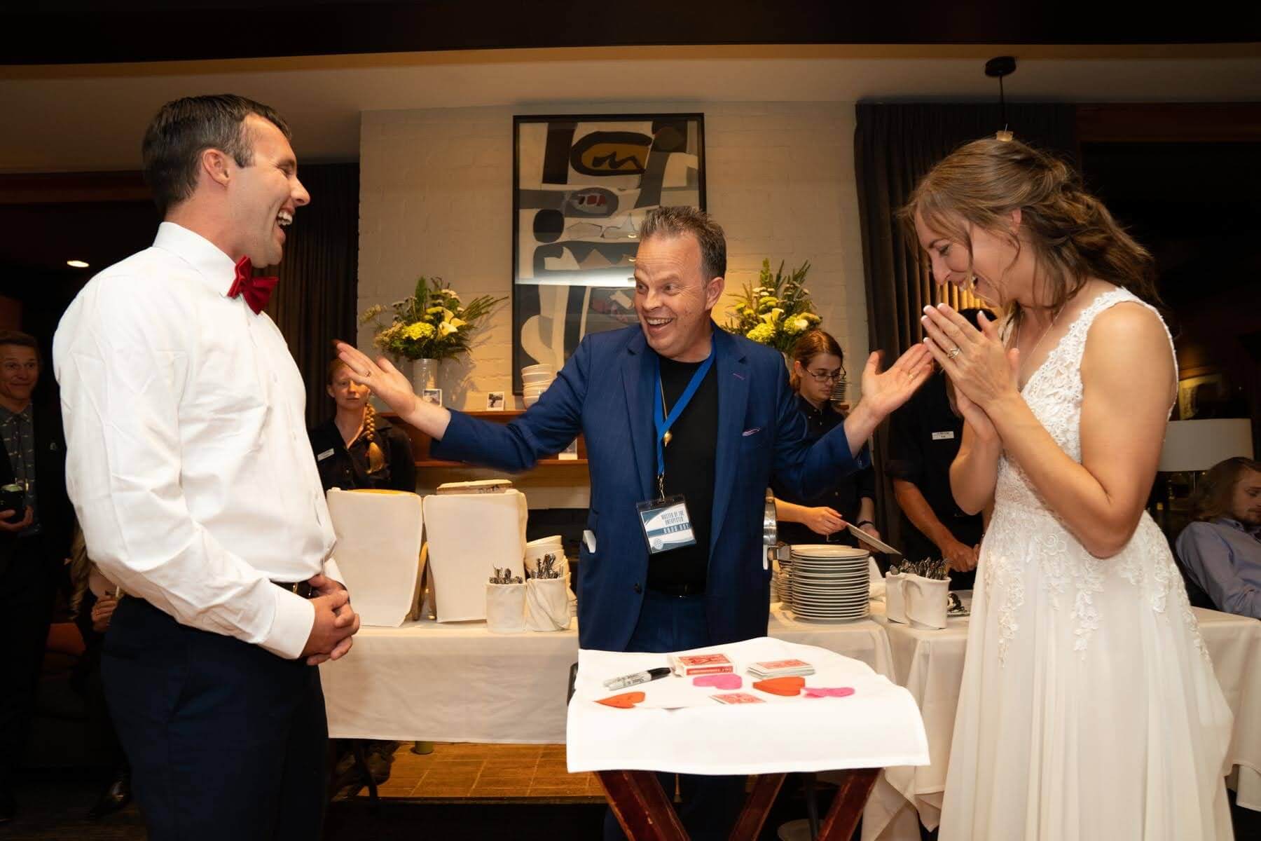Wedding Couple laughing in amazement at magic trick.